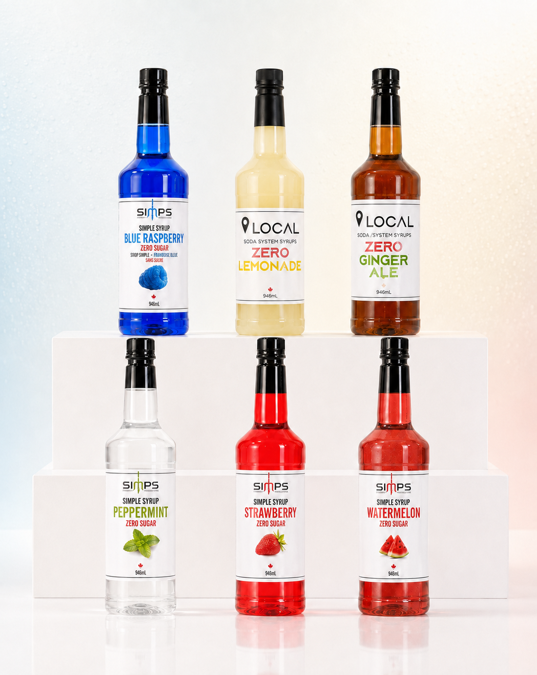 Six SIMPS and LOCAL zero sugar syrup bottles on a white backdrop: blue raspberry, zero lemonade, zero ginger ale, peppermint, strawberry and watermelon