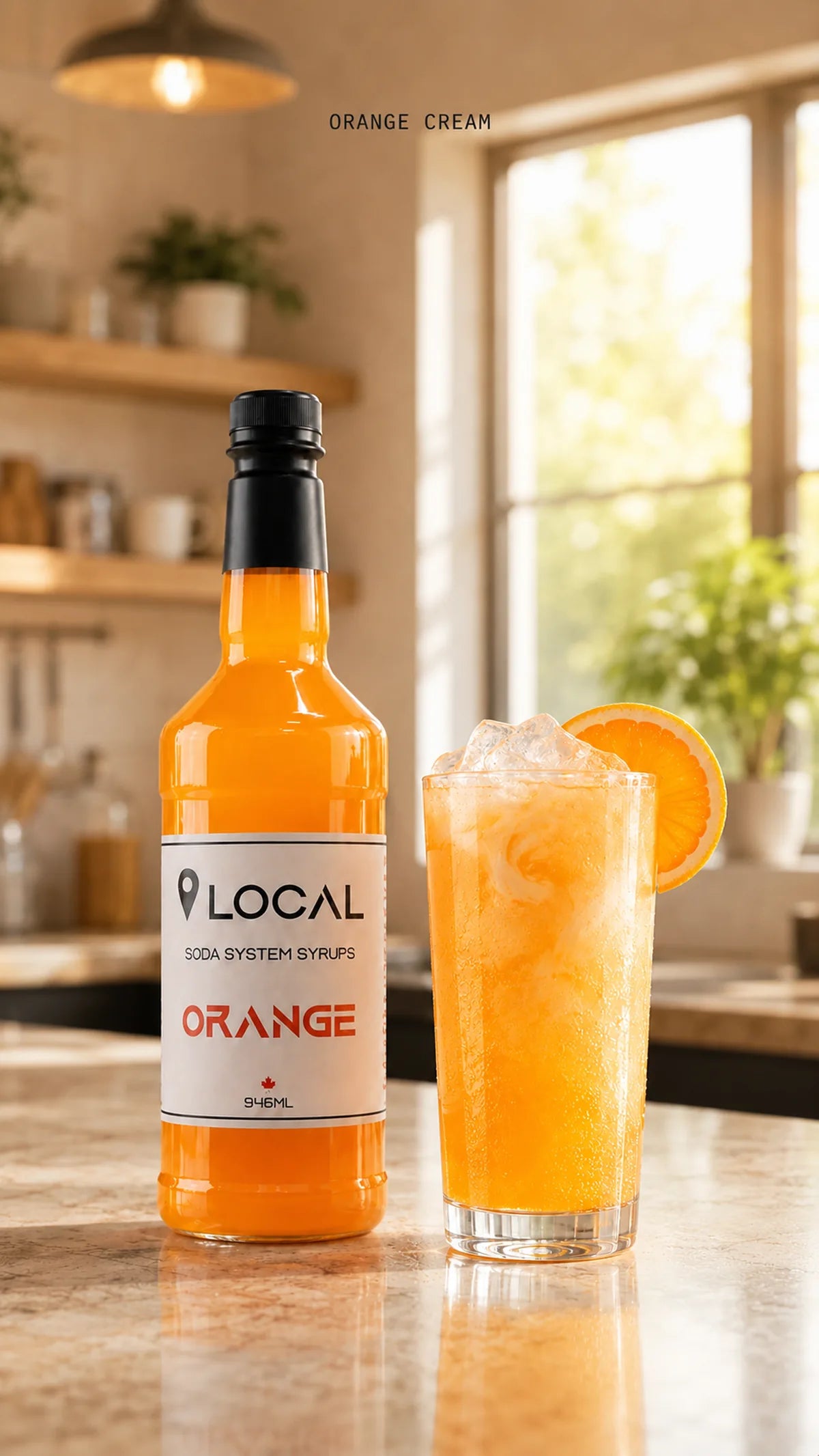 A bottle of SIMPS LOCAL Orange soda syrup beside a finished orange cream soda in a bright kitchen